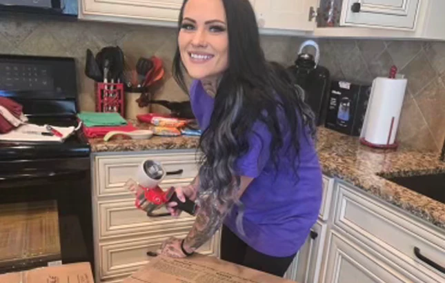 ID-Best-Moving-Company-packing Packing a moving box with a tape gun in a kitchen