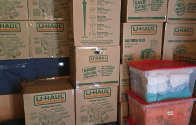 ID-Best-Moving-Company-unload Stacked moving boxes and storage bins ready to be loaded